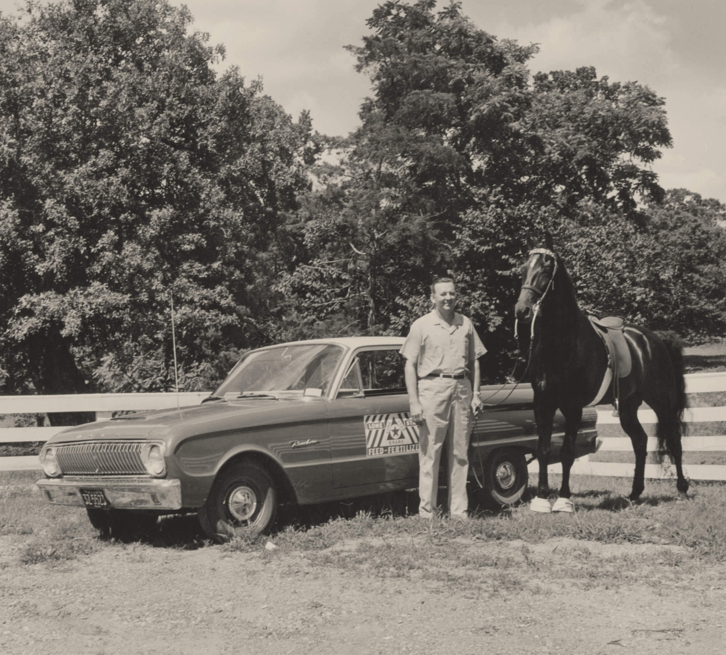 man with horse in front of a car with a lone star feed decal