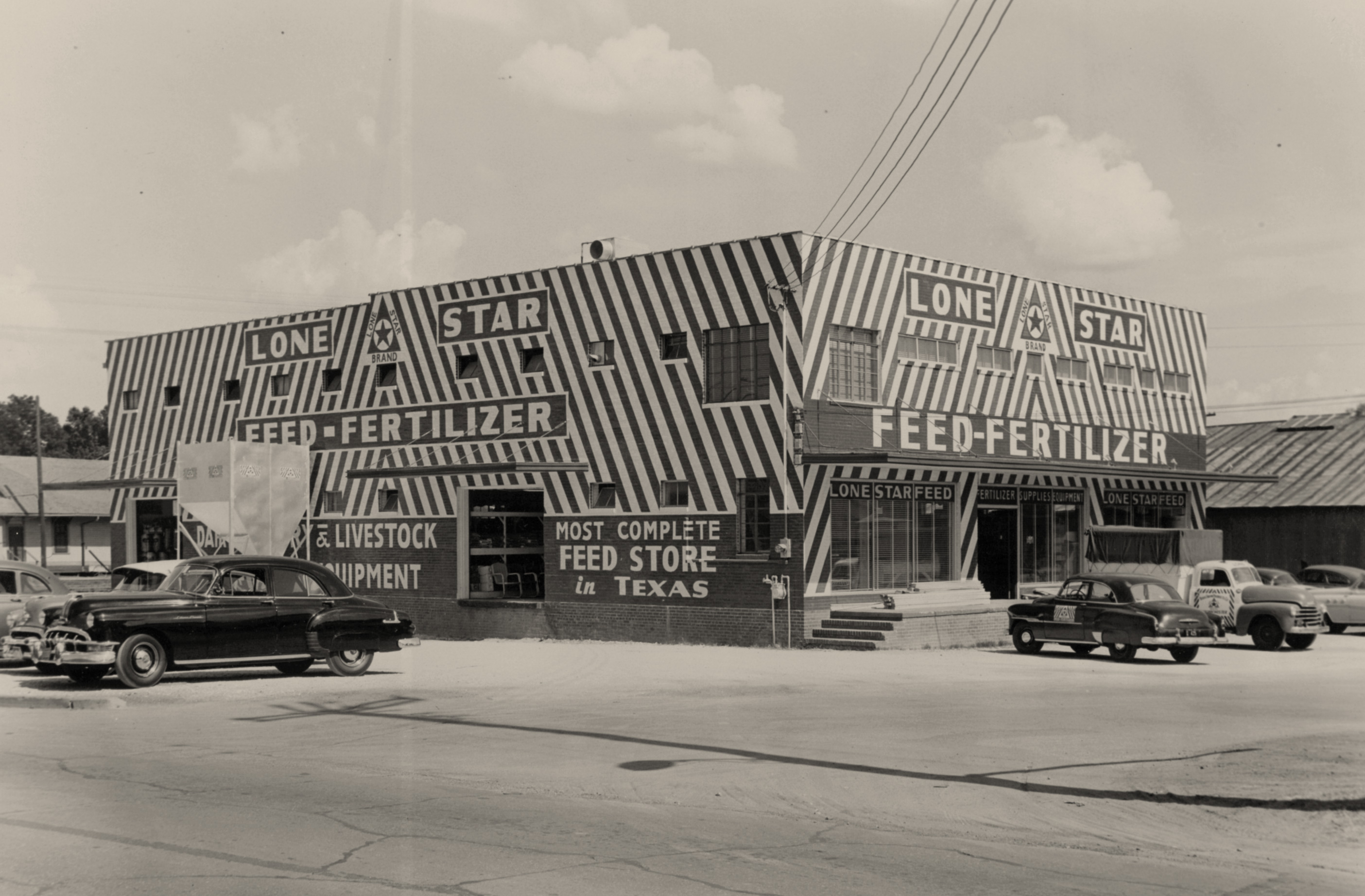 A vintage black and white photo of a past Lone Star feed store.