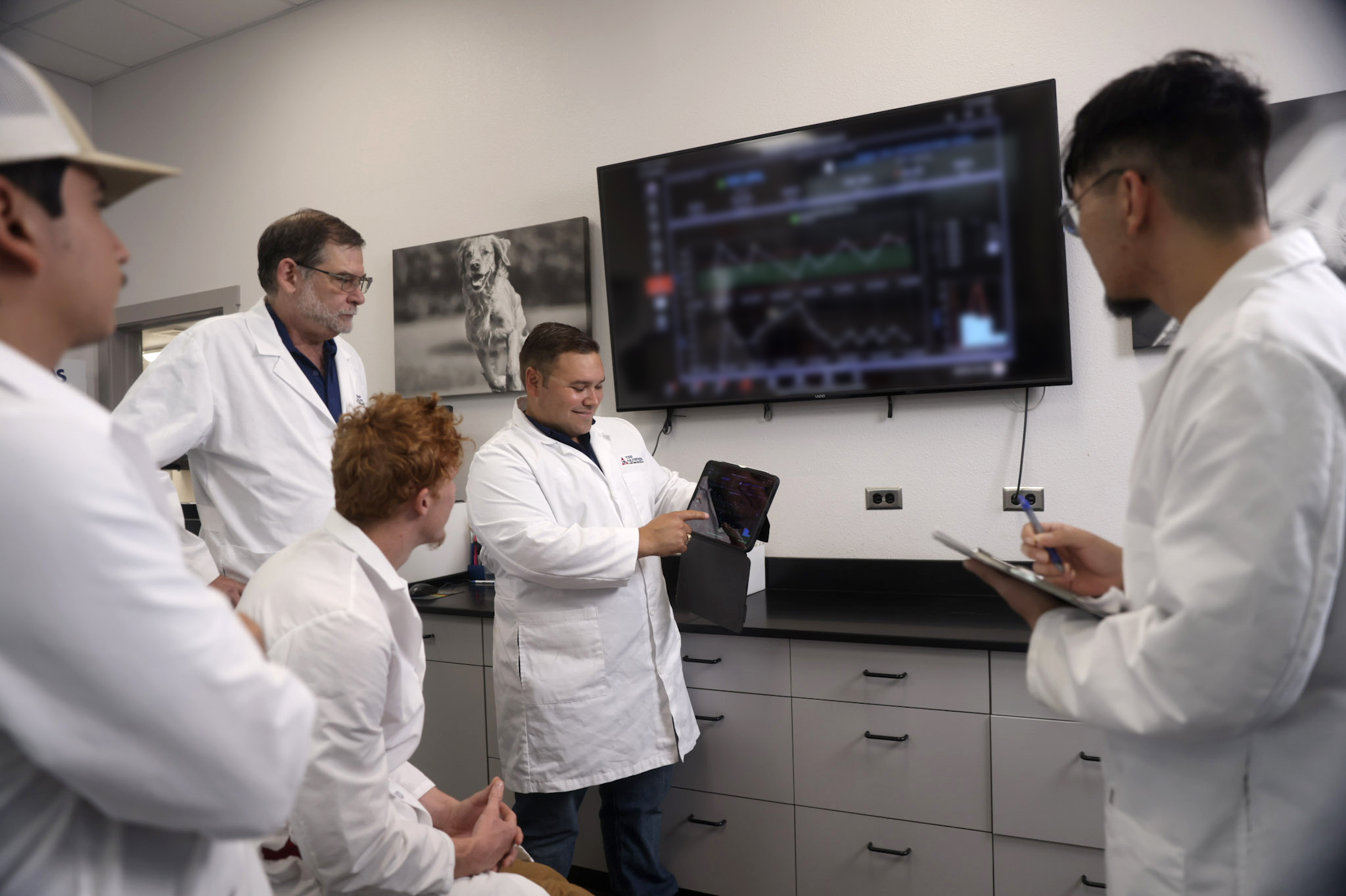 group of lab scientists in the TFP lab reviewing test results