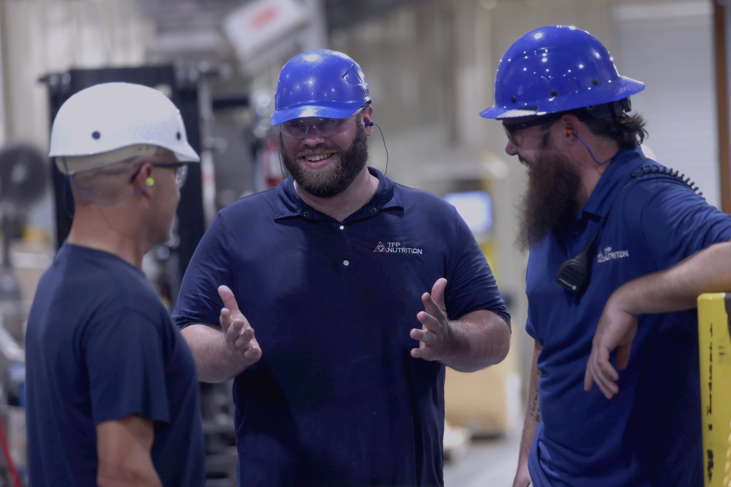 tfp employees in hard hats having a conversation