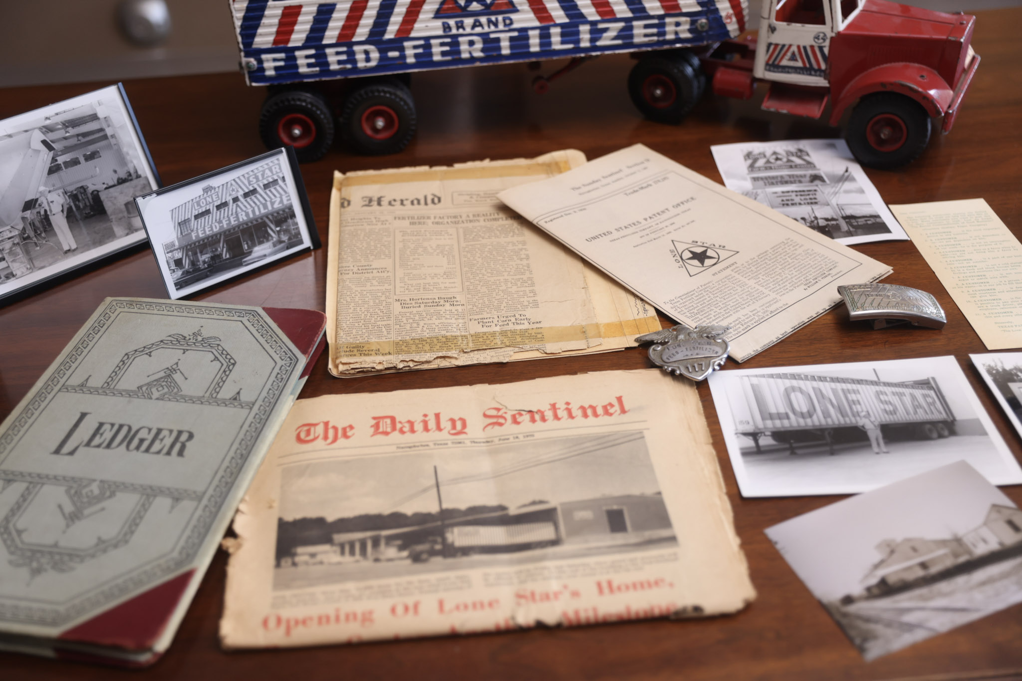 flat lay of old newspapers, pictures, and memorabilia