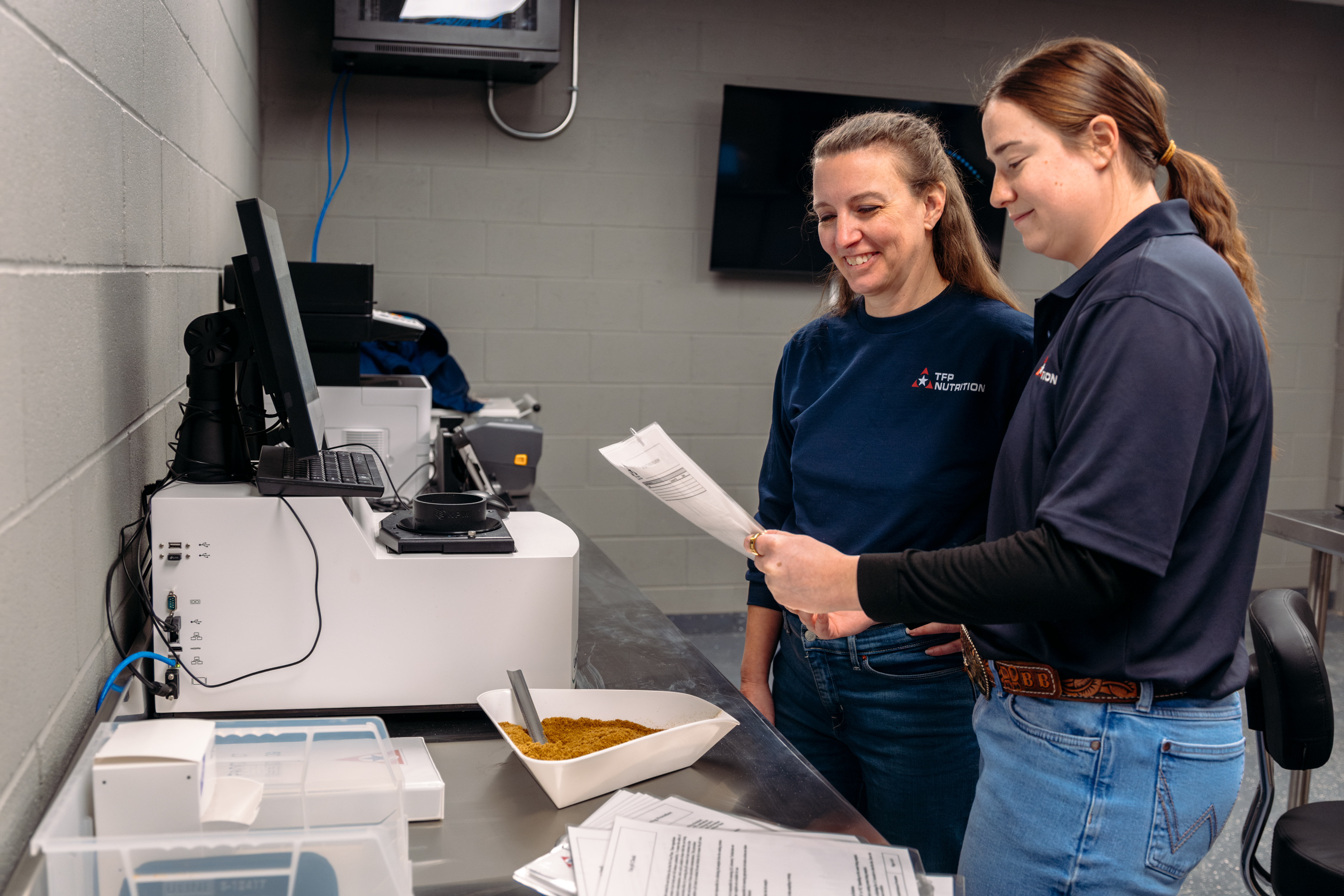 two women studying paper in sample lab