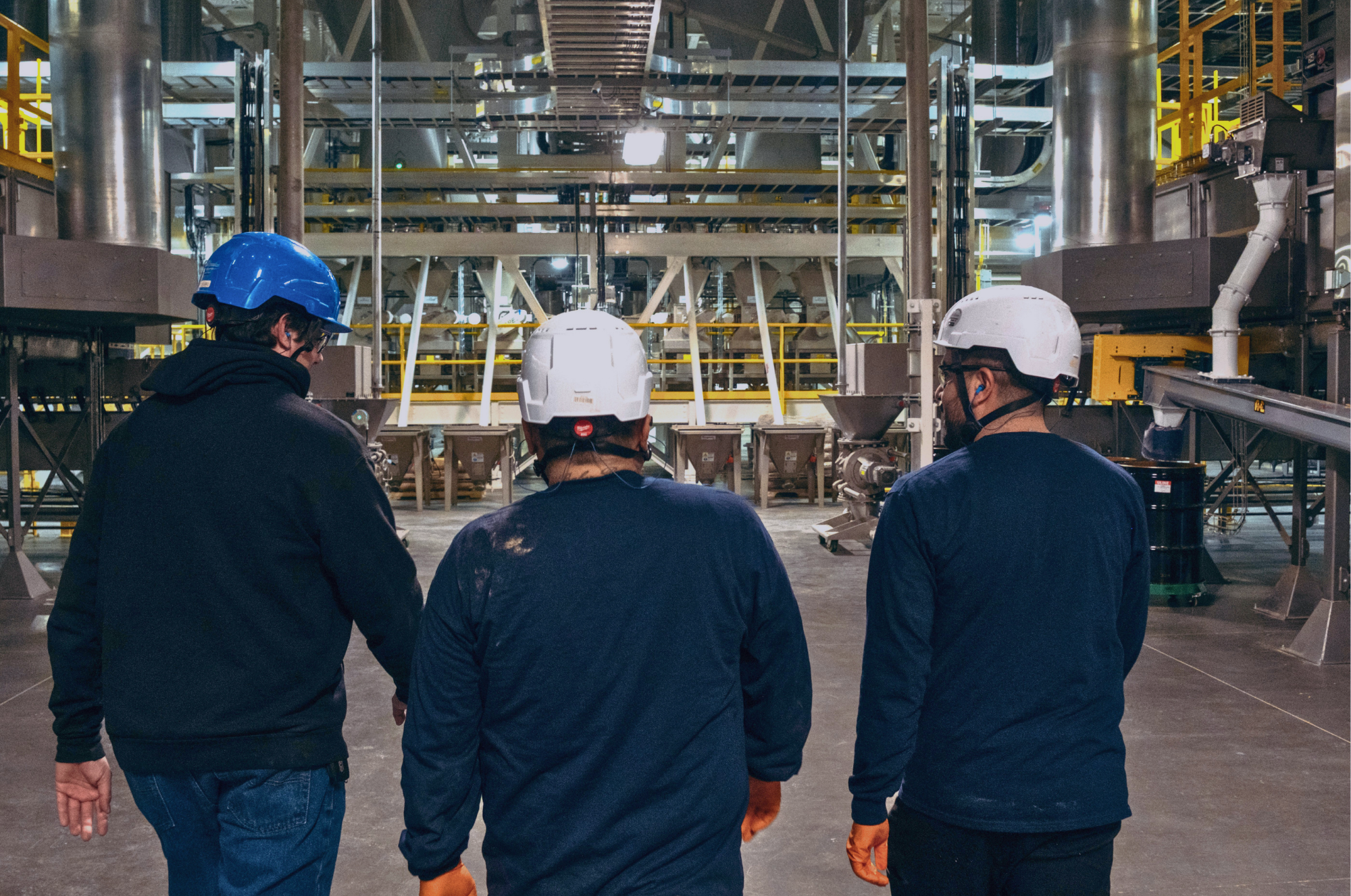 men walking into plant